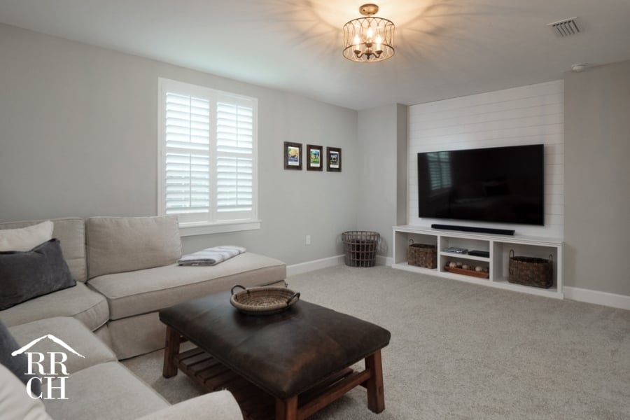 Custom Home Build Longleaf Living Area Den with Custom TV Wall Shiplap Accent and Custom Built-In Shelving | Robinson Renovation & Custom Homes, Inc.