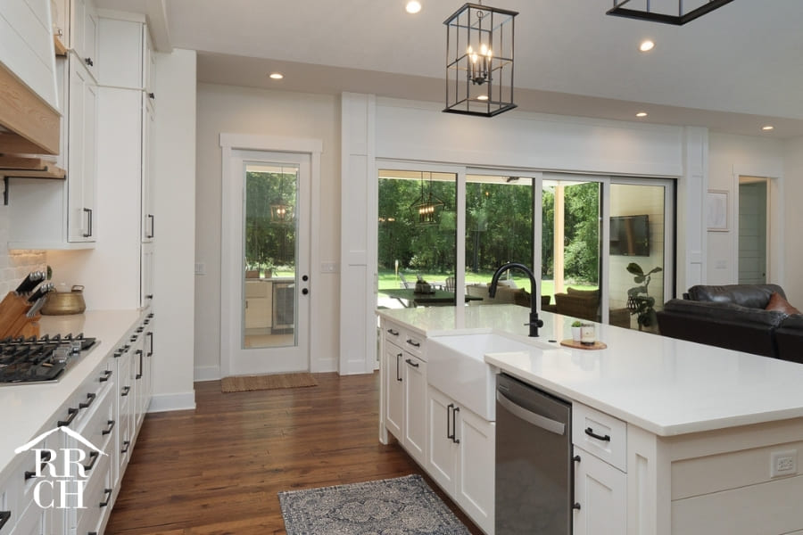 Custom Home Build Open Floor Plan Kitchen and Dining Area with Sliding Doors to Outdoor Living Area - Dylans Grove 2 | Robinson Renovation & Custom Homes, Inc.