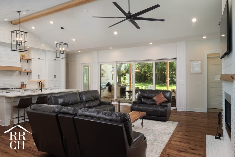 Custom Home Build Open Floor Plan Living and Kitchen Area Exposed Beam and Sliding Doors to Outdoor Living Area - Dylans Grove 2 | Robinson Renovation & Custom Homes, Inc.