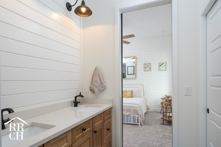 Custom Home Build Private Kids Bathroom Modern Farmhouse Style Light Fixtures Sliding Barn Door - Dylans Grove 2 | Robinson Renovation & Custom Homes, Inc.