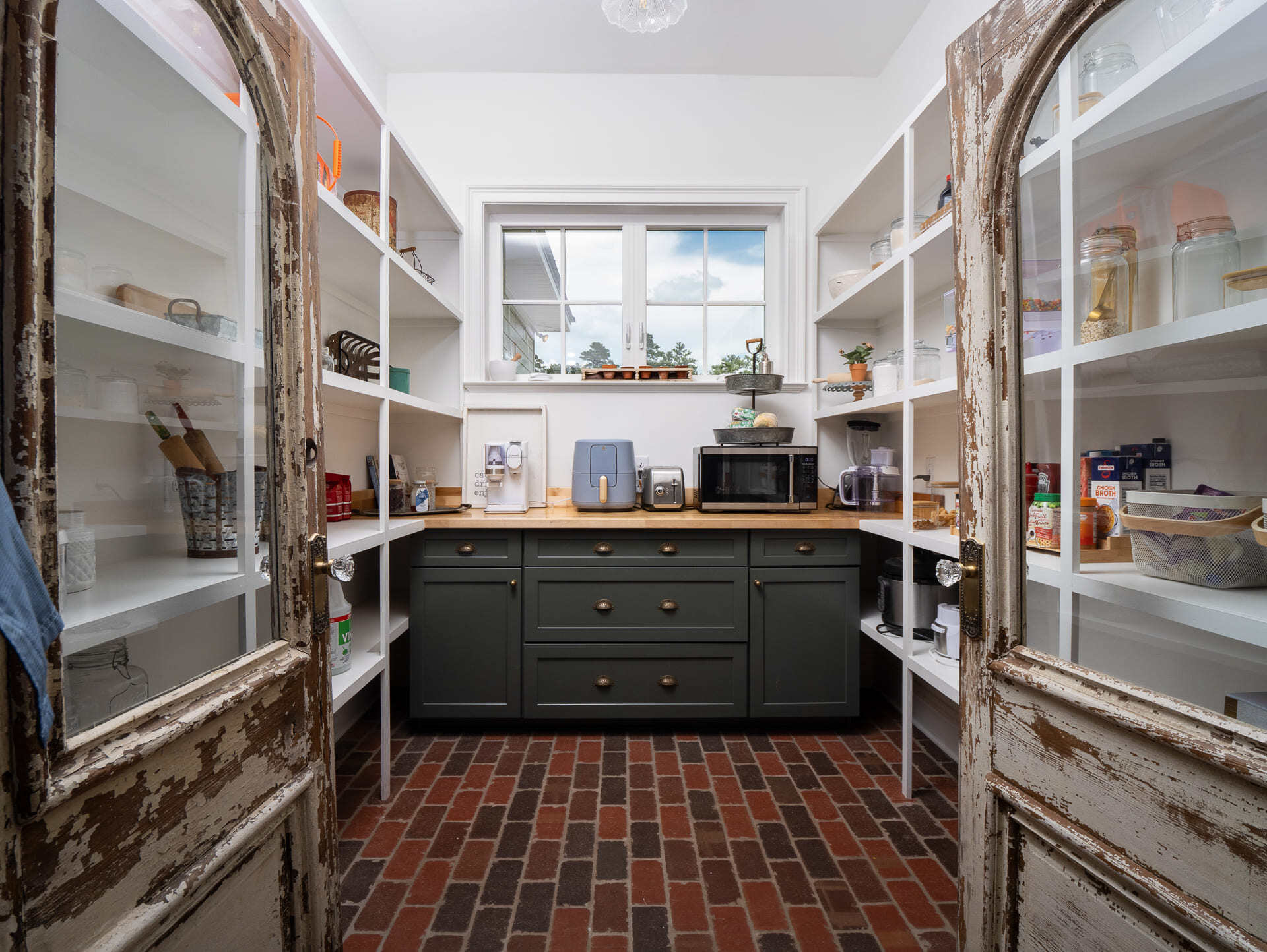 Walk In Pantry with Distressed Doors and Brick Tile in Custom Alachua Home Walk In Pantry with Distressed Doors and Brick Tile in Custom Alachua Home