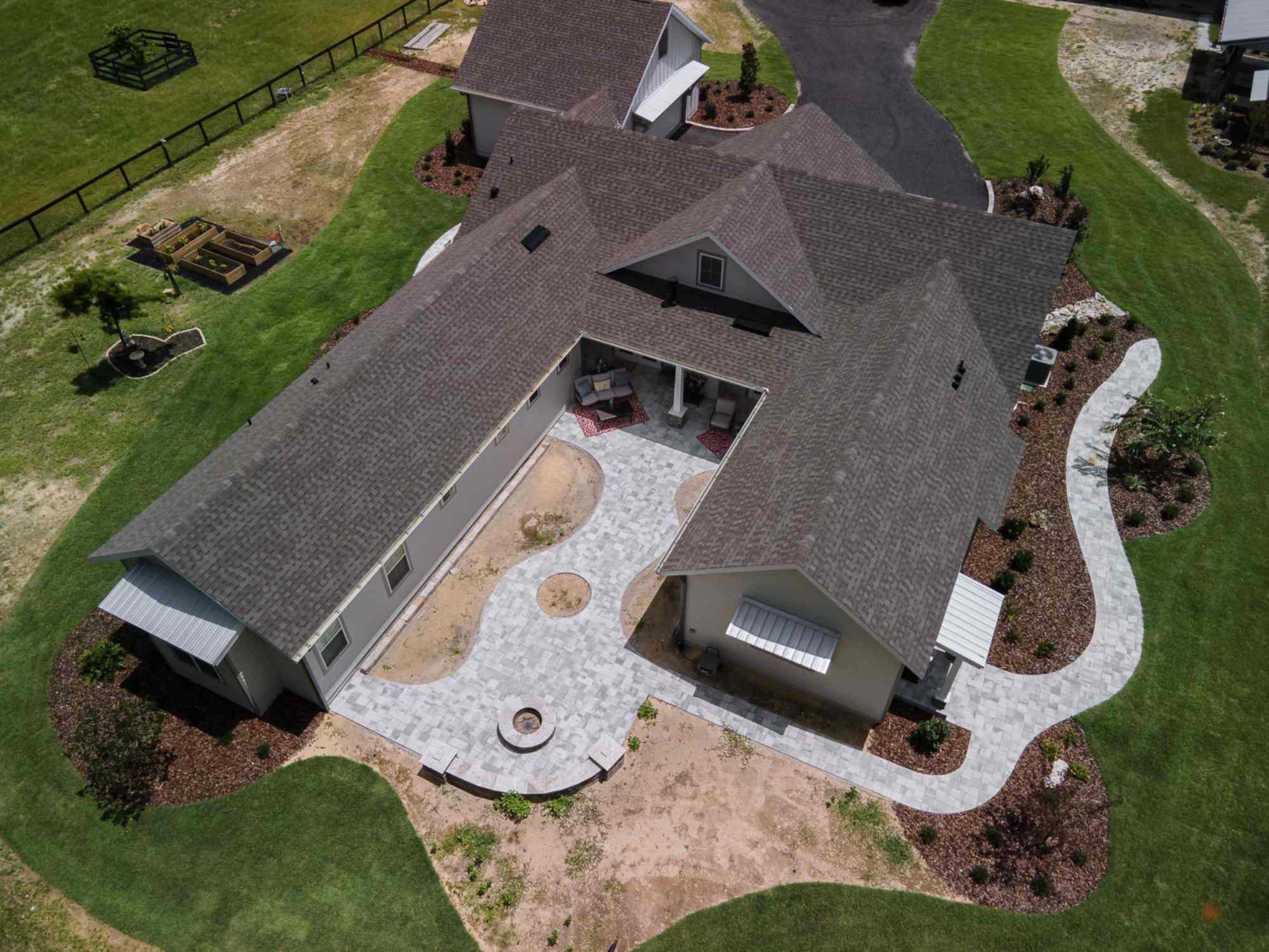 RRCH custom home in Jonesville, FL with aerial view of backyard courtyard, patio, and landscaped outdoor space
