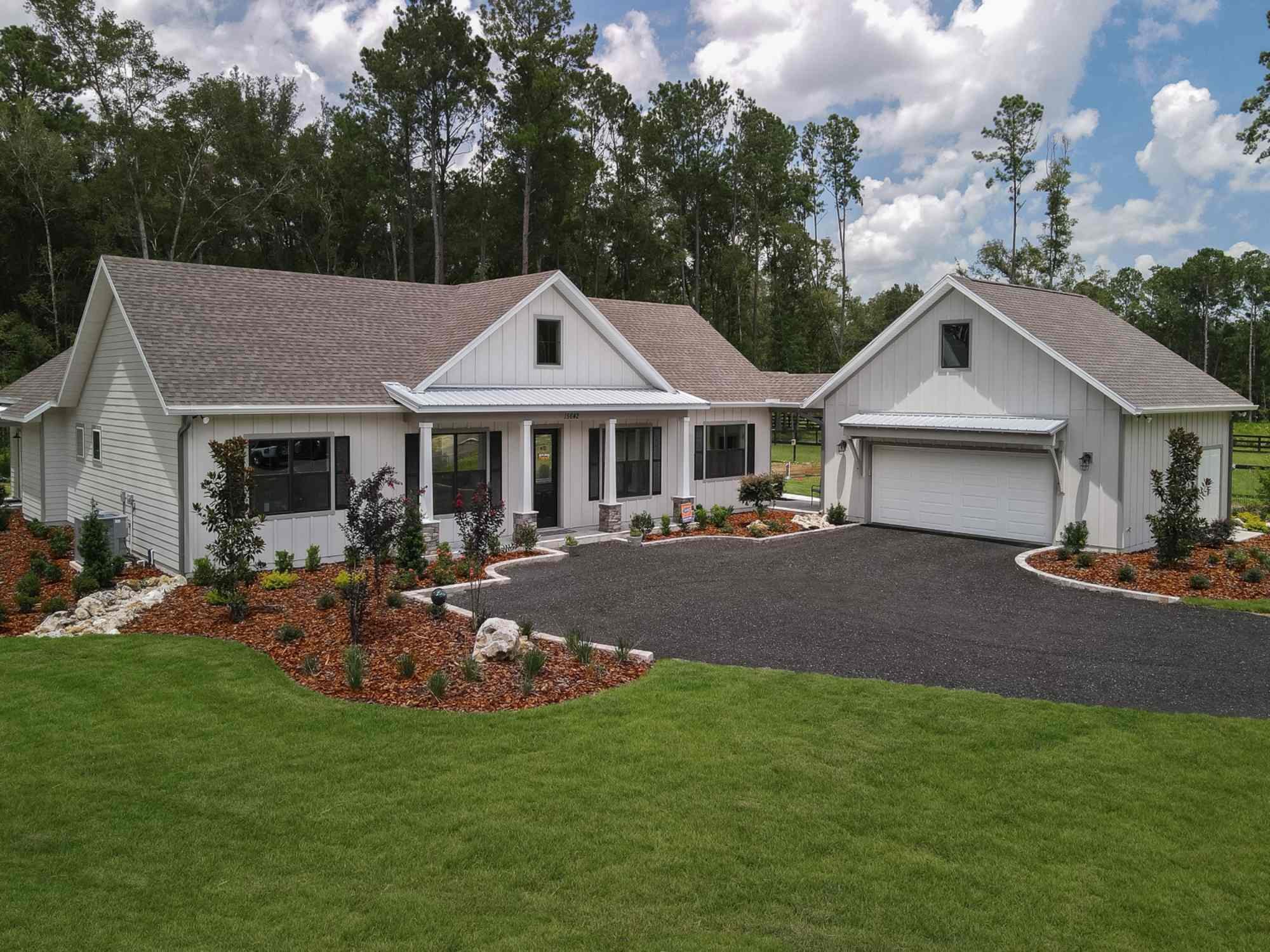 RRCH custom home in Jonesville, FL featuring modern farmhouse style, spacious driveway, and clean exterior design RRCH custom home in Jonesville, FL featuring modern farmhouse style, spacious driveway, and clean exterior design