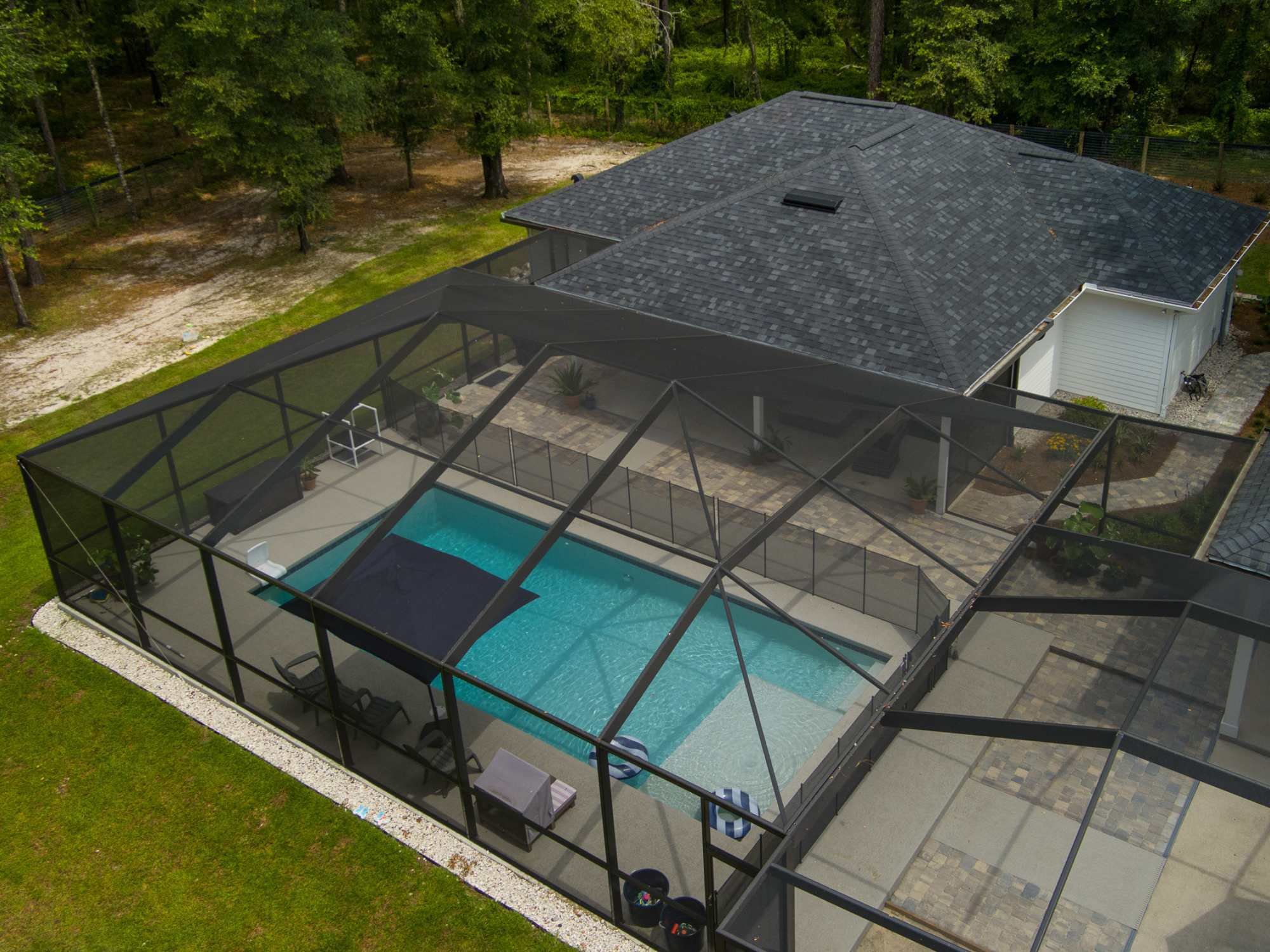 ADU with a screen enclosed pool that also leads to the main house by RRCH in Alachua County, FL