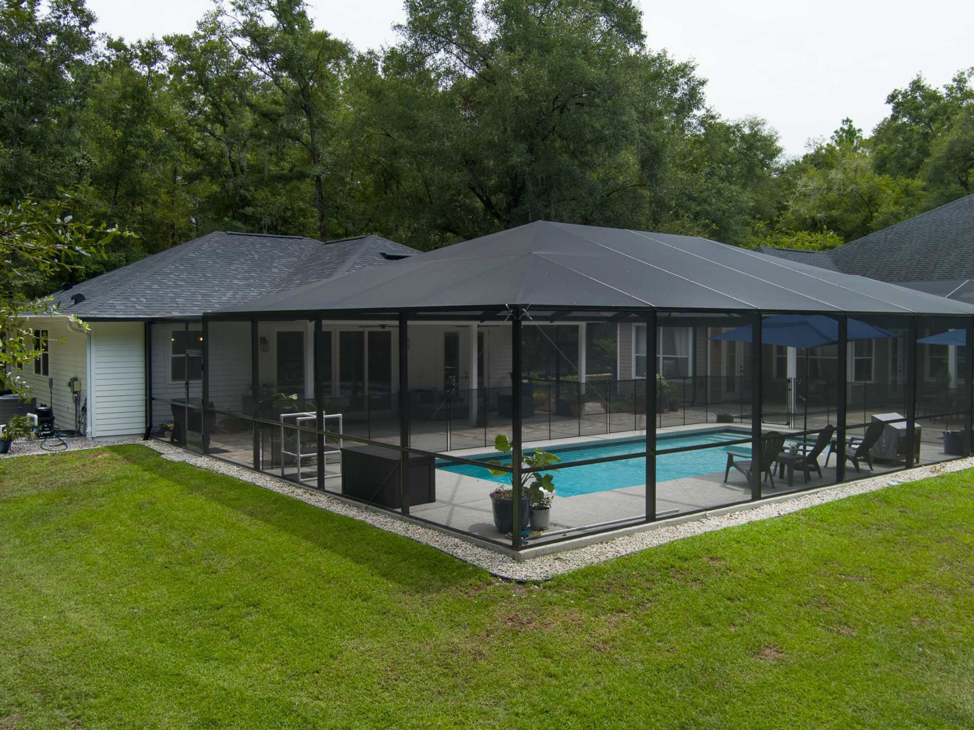 ADU with screen enclosed pool beside the main house by RRCH in Alachua County, FL