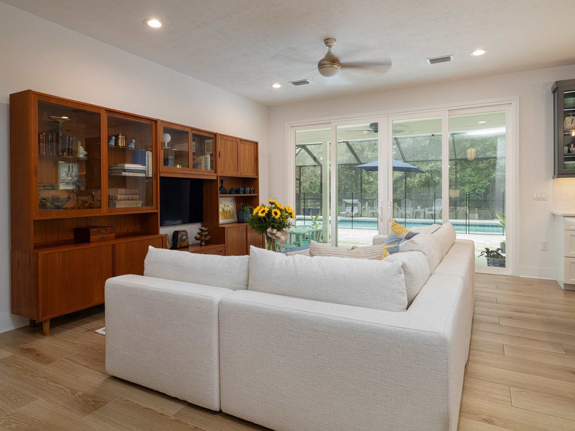 Living room with glass doors that lead to the pool in an ADU by RRCH in Alachua County, FL