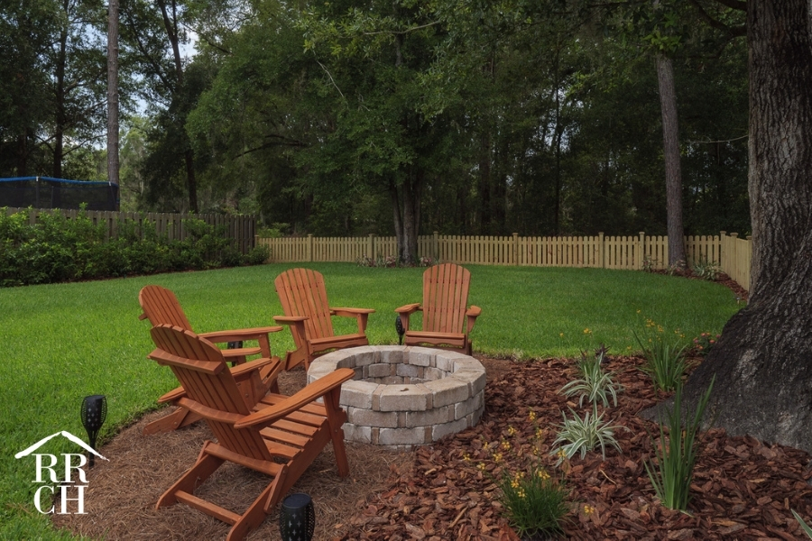 Custom Home Build Longleaf Backyard Landscaping with Firepit and Seating | Robinson Renovation & Custom Homes, Inc.