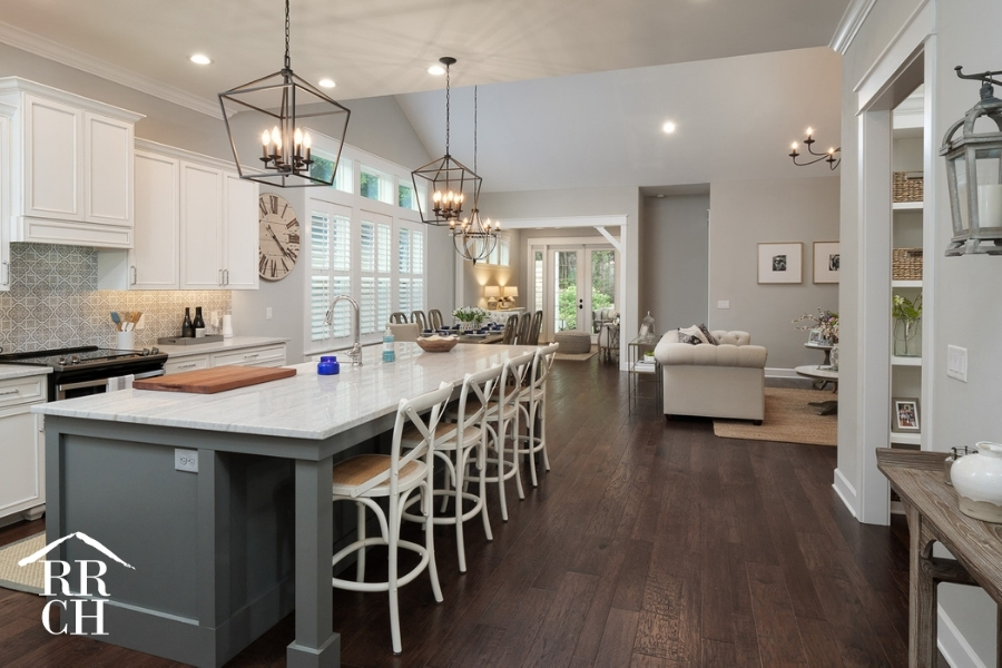 Custom Home Build Longleaf Open Concept Kitchen Dining and Living Area with Large Eat-In Kitchen Island and Modern Industrial Light Fixtures | Robinson Renovation & Custom Homes, Inc.
