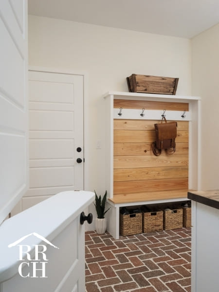 Custom Home Build Mudroom and Laundry Room with Half Swing Door and Custom Coat Rack - Dylans Grove 2 | Robinson Renovation & Custom Homes, Inc.