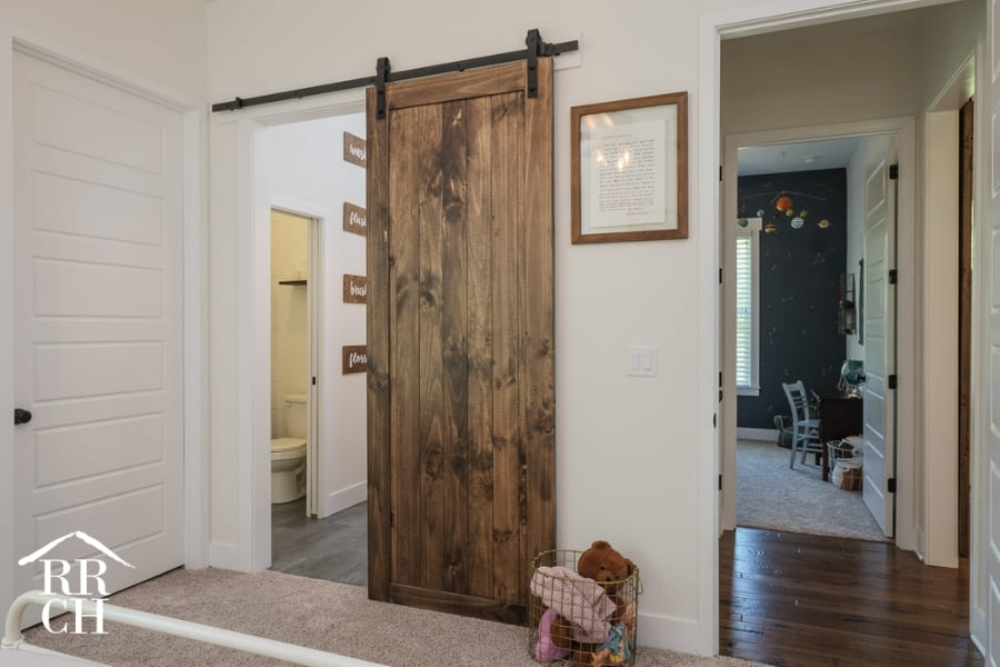 Custom Home Build Private Kids Bathroom with Sliding Barn Door - Dylans Grove 2 | Robinson Renovation & Custom Homes, Inc.
