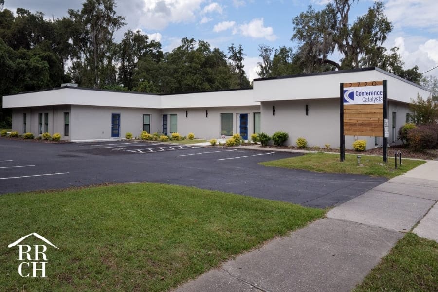 Modern Office Renovation Exterior with Wood Panel Sign in Parking Lot | Robinson Renovation and Custom Homes