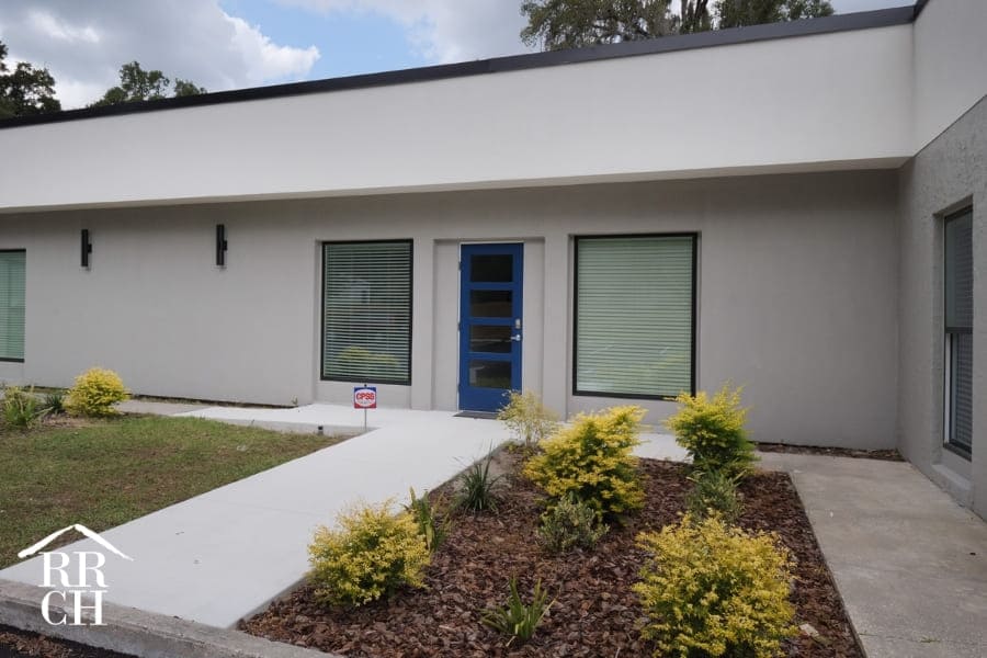 Office Renovation Modern White Exterior with Black Trim and Plant Bed | Robinson Renovation and Custom Homes
